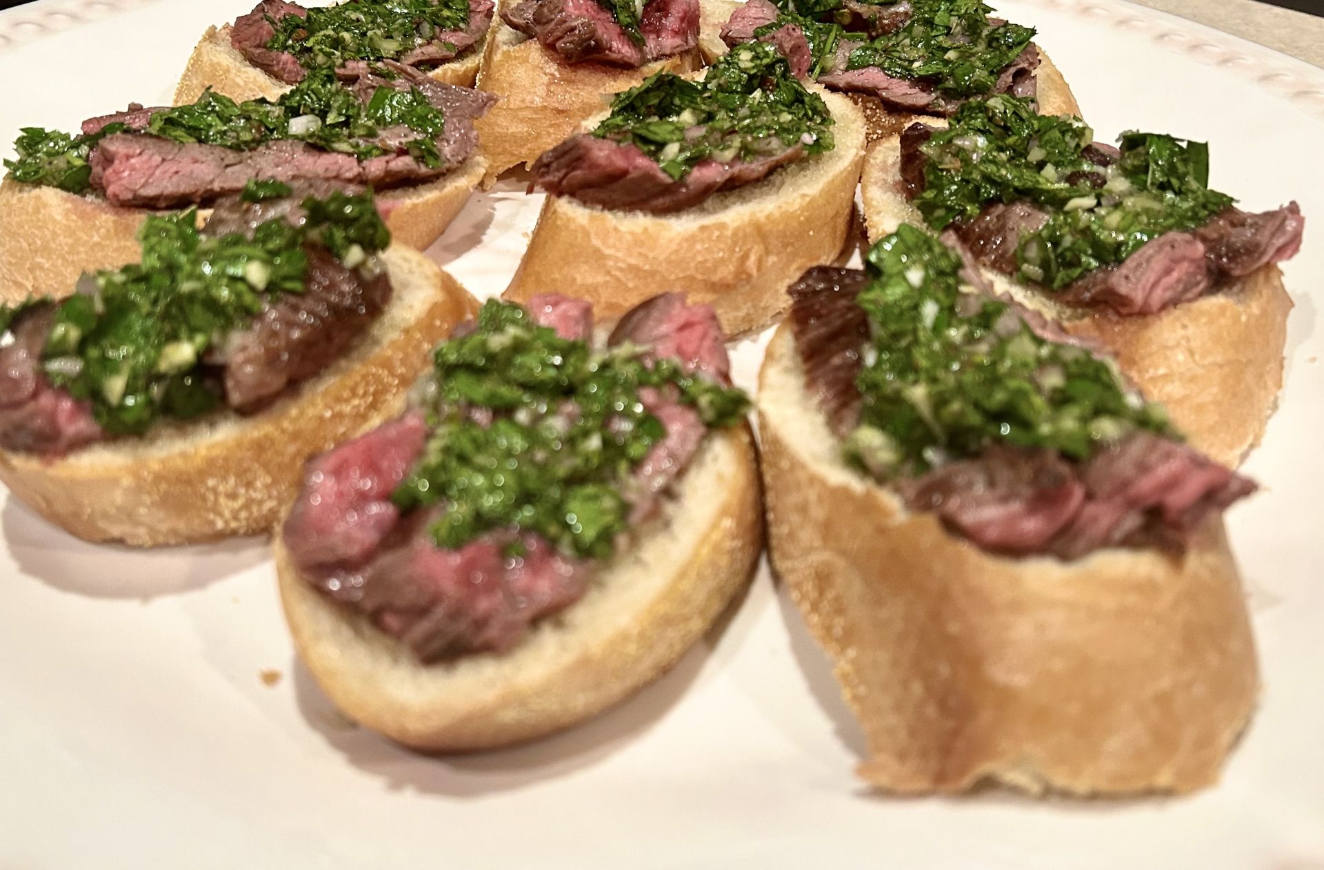 Marinated chimichurri flank steak toasts